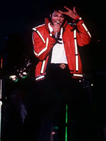 michael-jackson-concert-tokyo-japan-red-jacket-hand-on-head-singing-microphone-1987.jpg